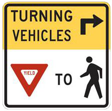 Figure 9 is a picture of a street sign that says that vehicles that turning right need to yield to pedestrians. 